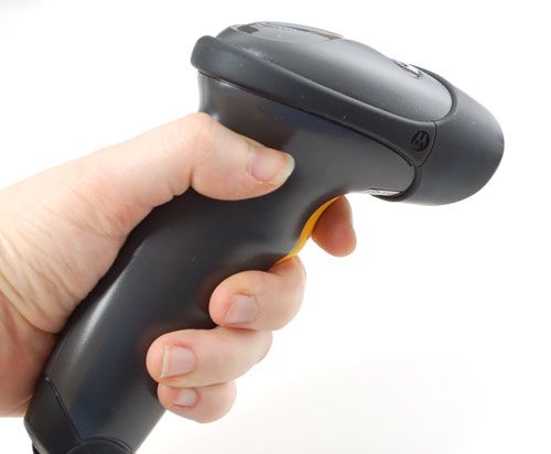 A hand holding a handheld scanner